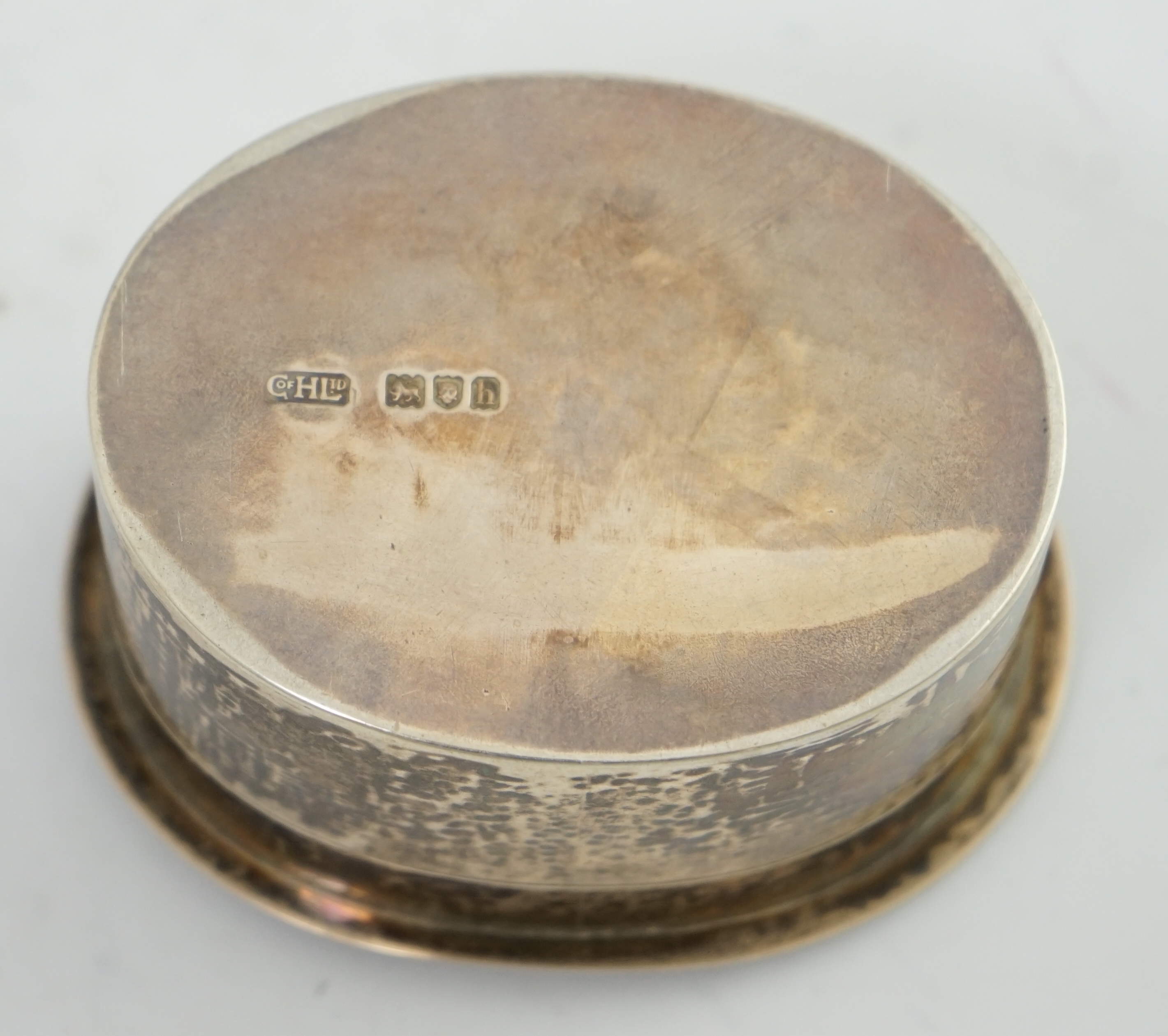 An Edwardian Arts & Crafts planished silver oval box by the Guild of Handicraft